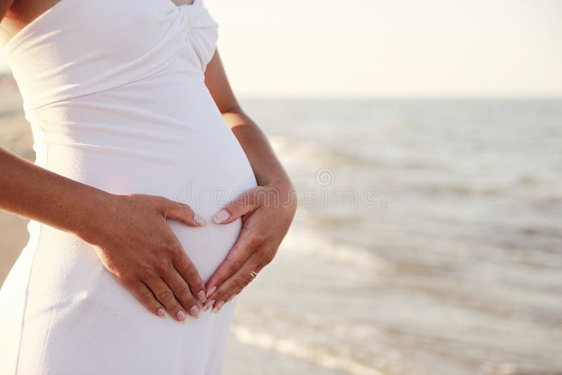 Pregnant woman on the beach