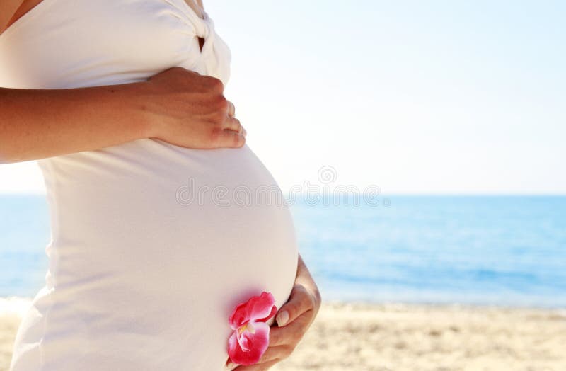 Pregnant woman on the beach