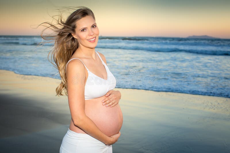 Pregnant woman on beach