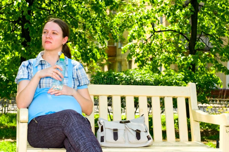 Pregnant woman with bottle of water