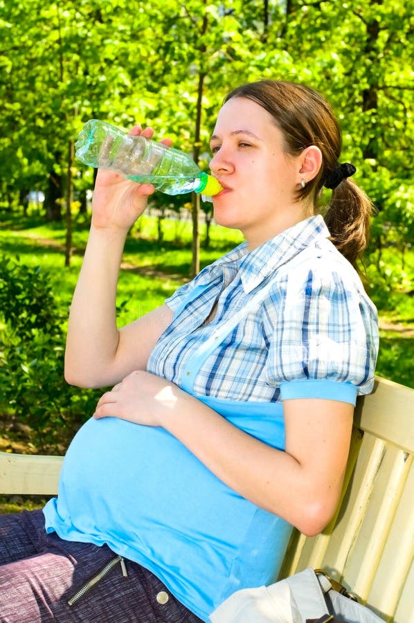 Pregnant woman with bottle of water