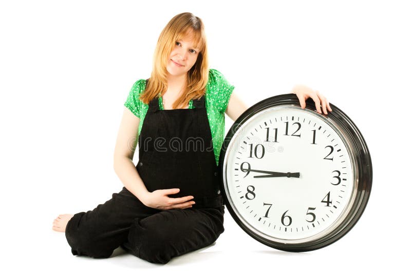 Pregnant woman with a clock