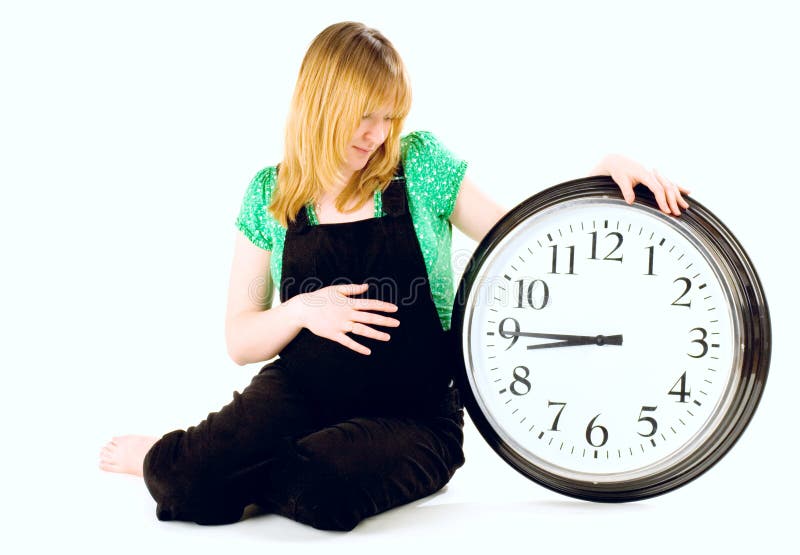 Pregnant woman with a clock