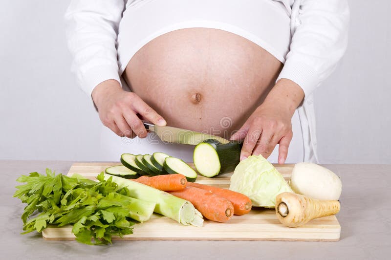 Pregnant woman cooking royalty free stock photo Pregnant woman cooking royalty free stock photo