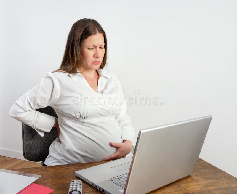 Pregnant Woman at Desk Feeling Labor Pains