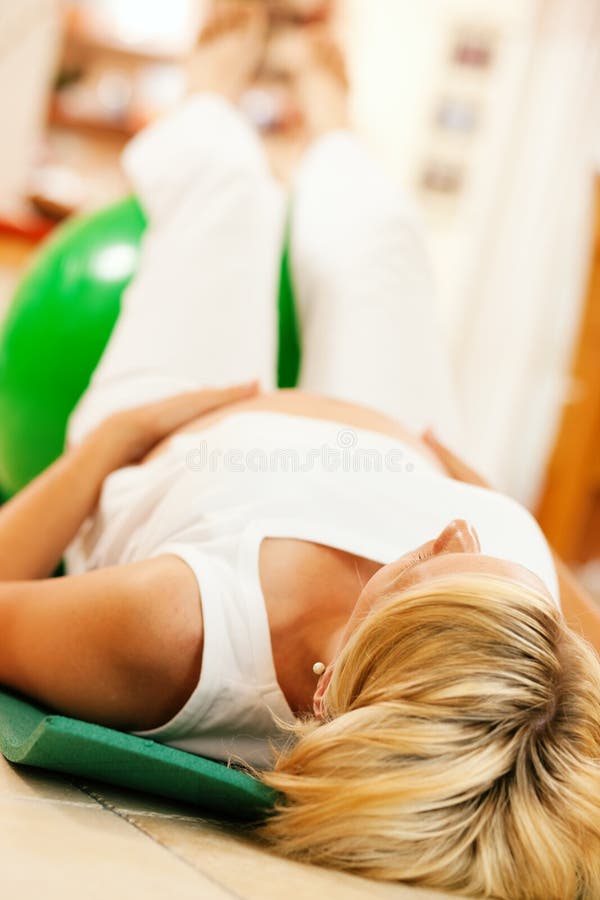 Pregnant woman doing pregnancy gymnastics stock image Pregnant woman doing pregnancy gymnastics stock image