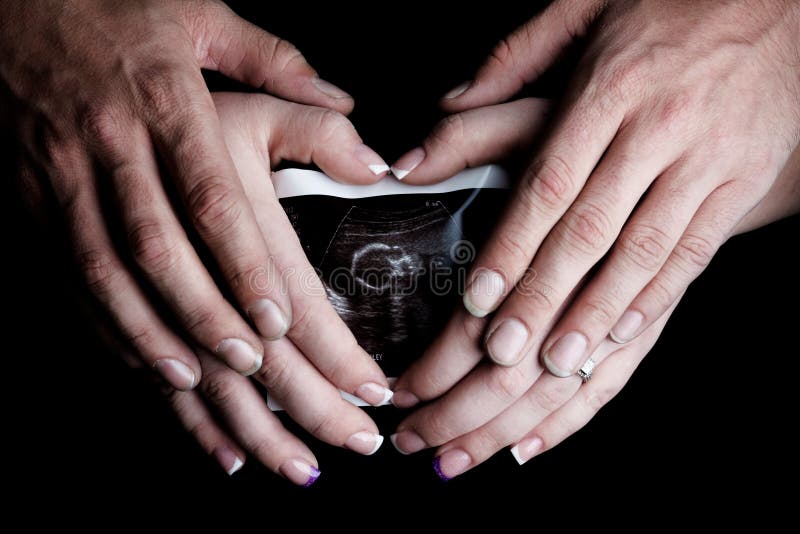 Pregnant Woman & Father Holding Belly Ultrasound stock photography Pregnant Woman & Father Holding Belly Ultrasound stock photography