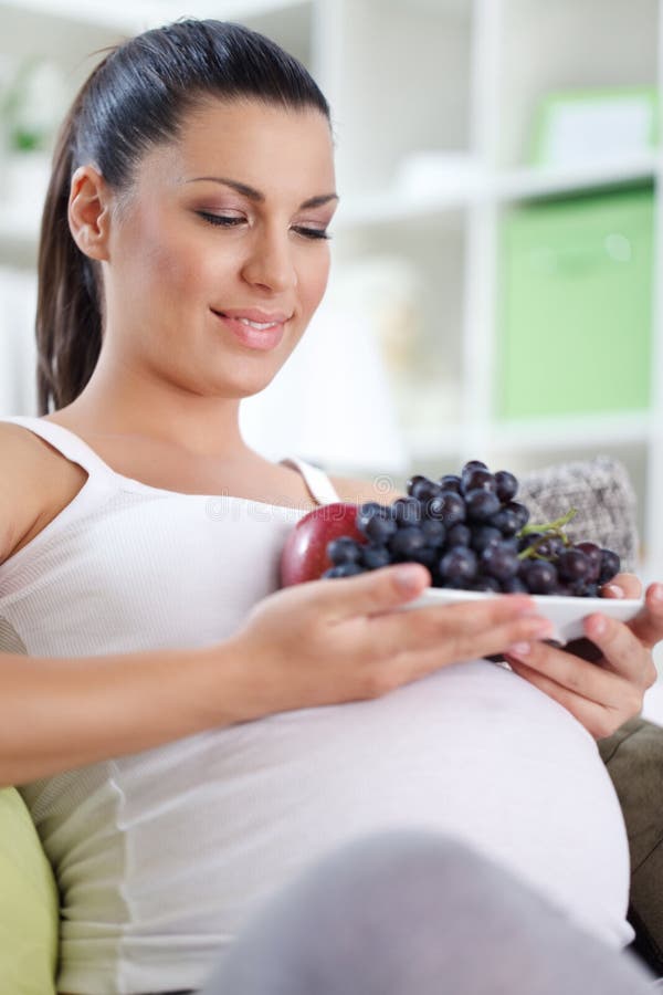 Pregnant woman with fruits royalty free stock photos