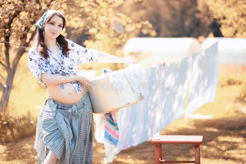 Pregnant Woman Hanging Sheets on the Rope for Drying Stock Image ...