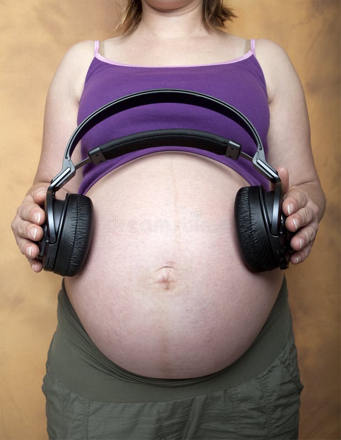 Pregnant Woman with Headphones on Stomach Stock Image - Image of  development, pregnancy: 14355235