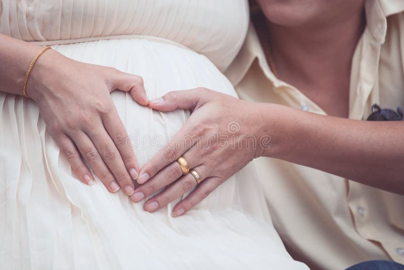 Pregnant Woman And Her Husband Making Hand Heart Shape Together Stock 