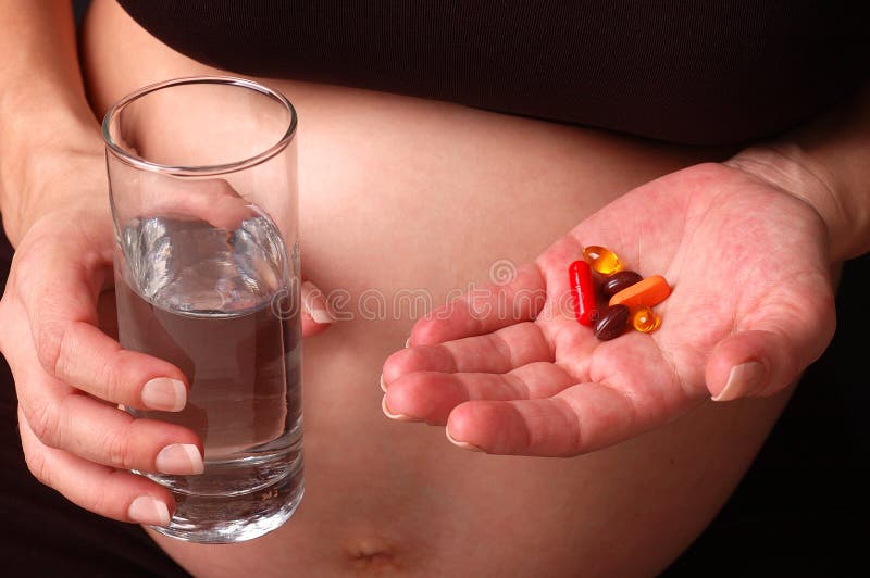 Pregnant woman holding medication