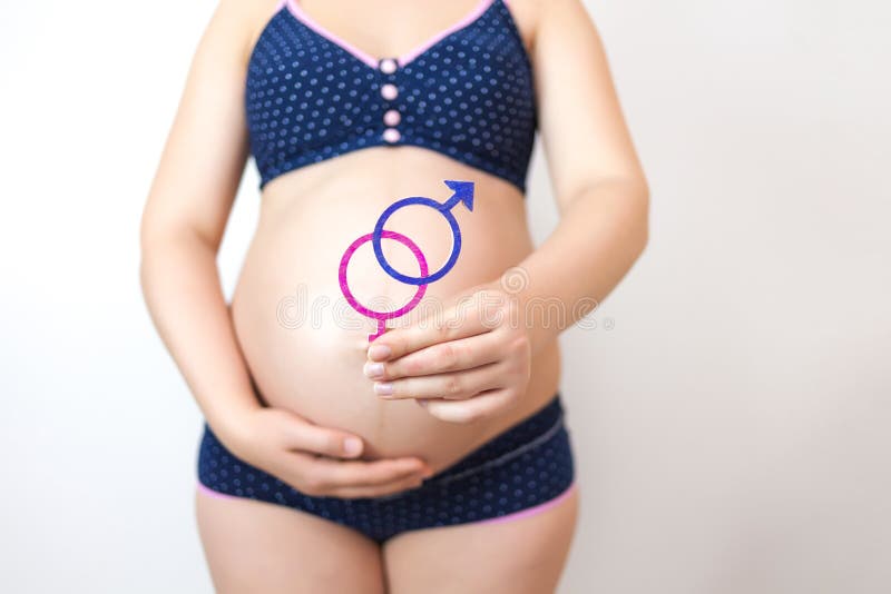 A Pregnant Woman Holds a Symbol of Gender Equality Against the Background  of Her Tummy Stock Image - Image of motherhood, life: 196346397