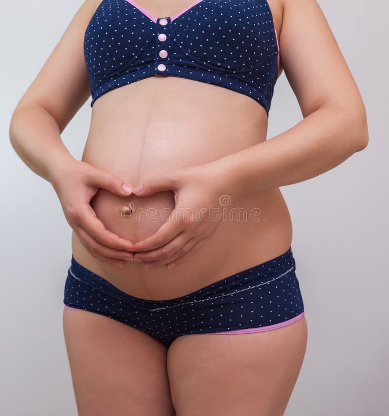 A Pregnant Woman Holds a Symbol of Gender Equality Against the Background  of Her Tummy Stock Image - Image of motherhood, life: 196346397