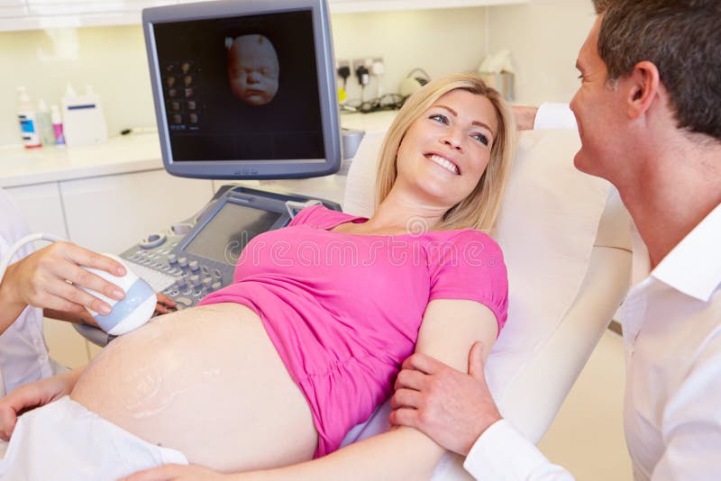Pregnant Woman And Partner Having 4D Ultrasound Scan stock photos Pregnant Woman And Partner Having 4D Ultrasound Scan stock photos