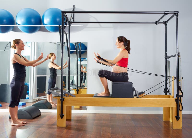 Pregnant woman pilates reformer short box stock photography Pregnant woman pilates reformer short box stock photography