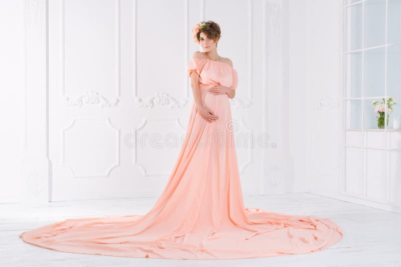 Pregnant woman in pink evening dress. Fashion shot. stock photos Pregnant woman in pink evening dress. Fashion shot. stock photos