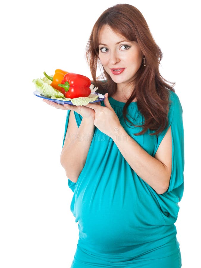 A pregnant woman with a plate of vegetables