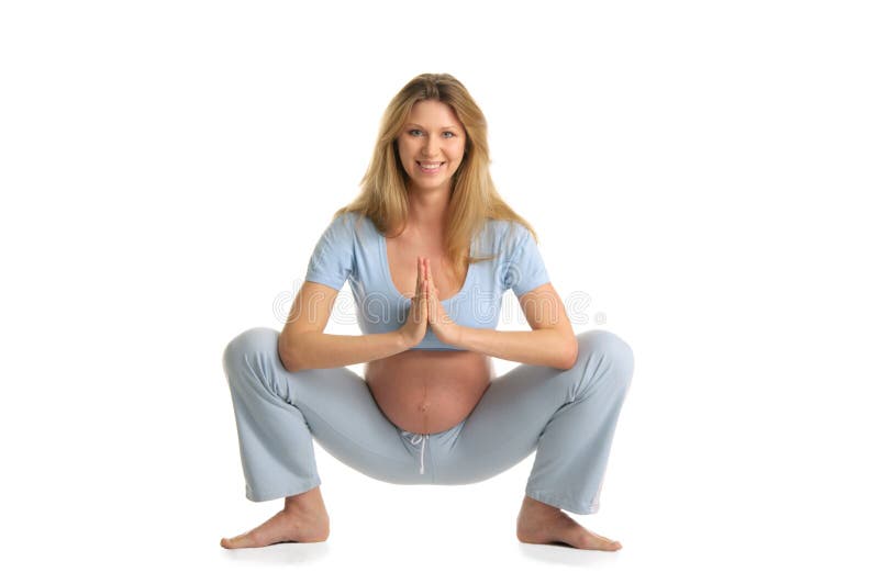 Pregnant woman practicing yoga, standing