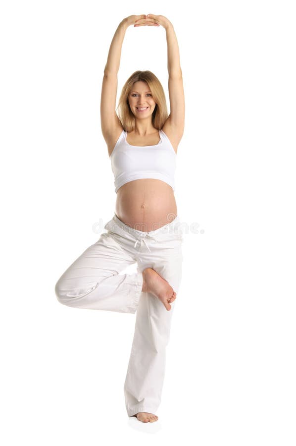 Pregnant woman practicing yoga, standing