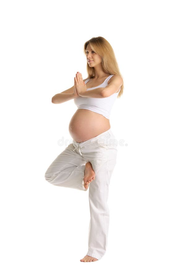 Pregnant woman practicing yoga, standing