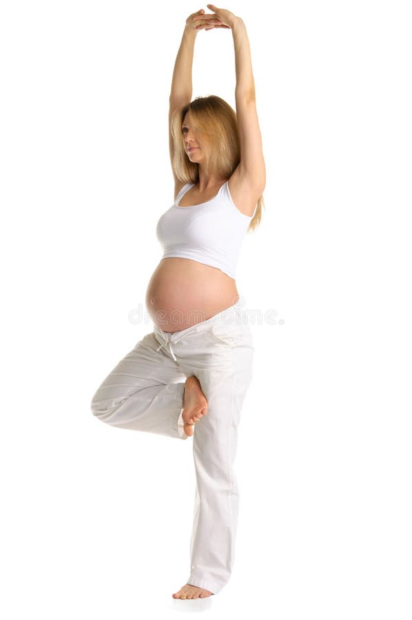 Pregnant woman practicing yoga, standing