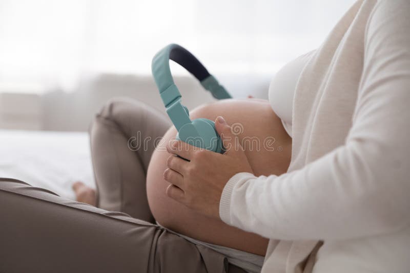 Melodies in the womb: Headphones placed on a pregnant belly, bonding  through music, a heartwarming connection between mother and baby Stock  Photo - Alamy