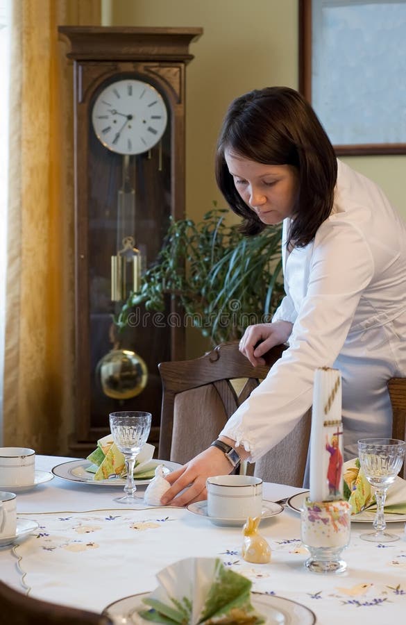 Pregnant woman setting table