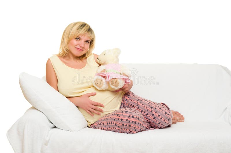 Pregnant woman on sofa stock image. Image of cushion 48008057