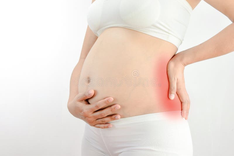Pregnant woman with a strong pain massaging her back :Pelvic pain or lower back pain in pregnancy