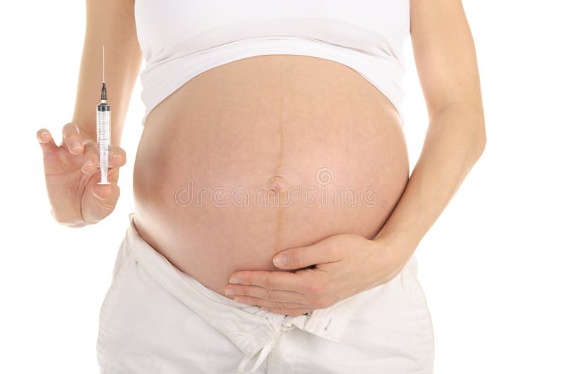 Pregnant woman with syringe in hand