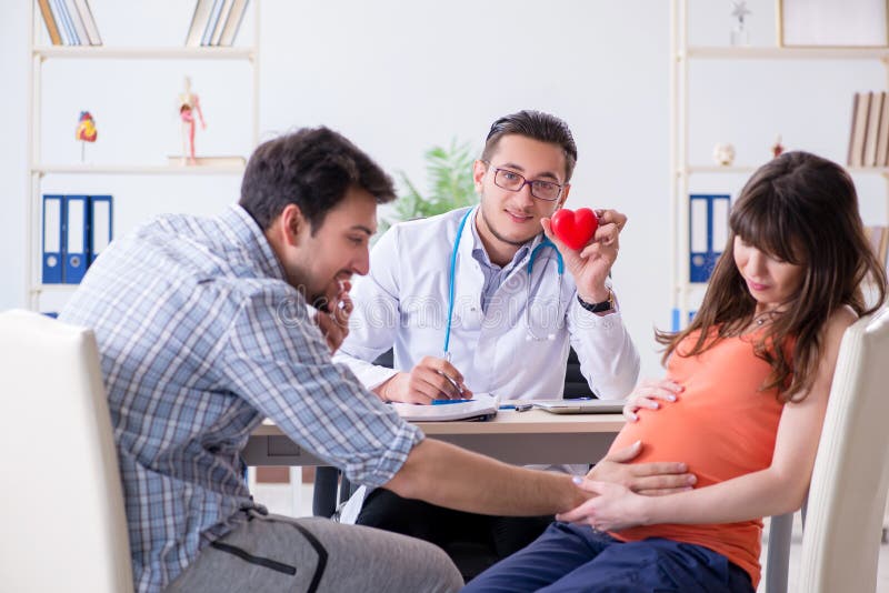 The Pregnant Woman With Her Husband Visiting The Doctor In Clinic Stock Image Image Of Husband 