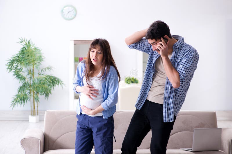 The pregnant woman with husband at home stock photography The pregnant woman with husband at home stock photography