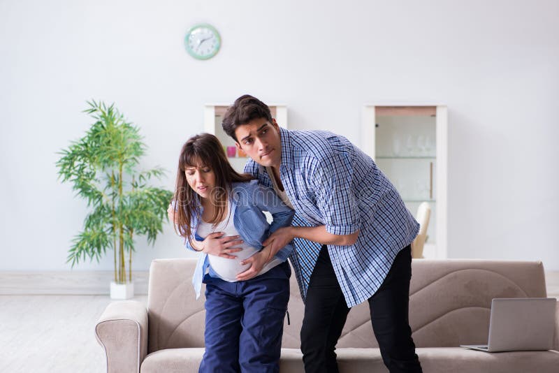 The pregnant woman with husband at home stock photo The pregnant woman with husband at home stock photo