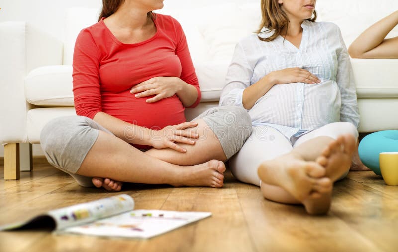 Pregnant women on sofa stock image. Image of positive 42892069
