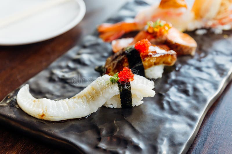 Premium Sushi Set include Deep fried Shrimp with Sea Urchin, Foie Gras, Salmon and Engawa on The Black Stone Plate. royalty free stock images Premium Sushi Set include Deep fried Shrimp with Sea Urchin, Foie Gras, Salmon and Engawa on The Black Stone Plate. royalty free stock images