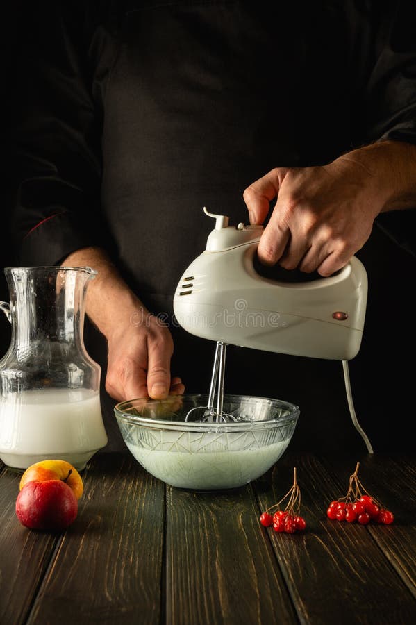 Premium Photo  Making a milkshake with an electric hand mixer refreshing  drink by the hands of the chef