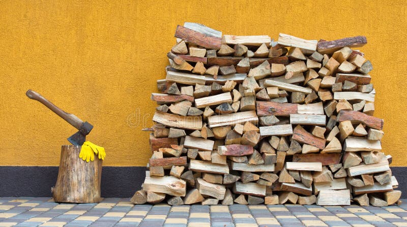 Preparation of firewood for the winter. Firewood background. Background of dry chopped firewood. Wooden background.Stacks of Firew
