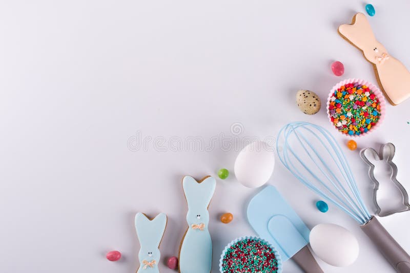Preparation of gingerbread cookies. Easter cookies in the shape of a funny rabbit , tools necessary to make gingerbread pastry,. Colored sprinkles. Easter stock photos Preparation of gingerbread cookies. Easter cookies in the shape of a funny rabbit , tools necessary to make gingerbread pastry,. Colored sprinkles. Easter stock photos