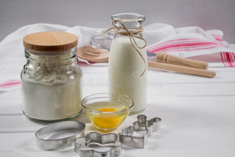 Preparation of gingerbread man cookies. Ingredients, cookie cutters and kitchen tools