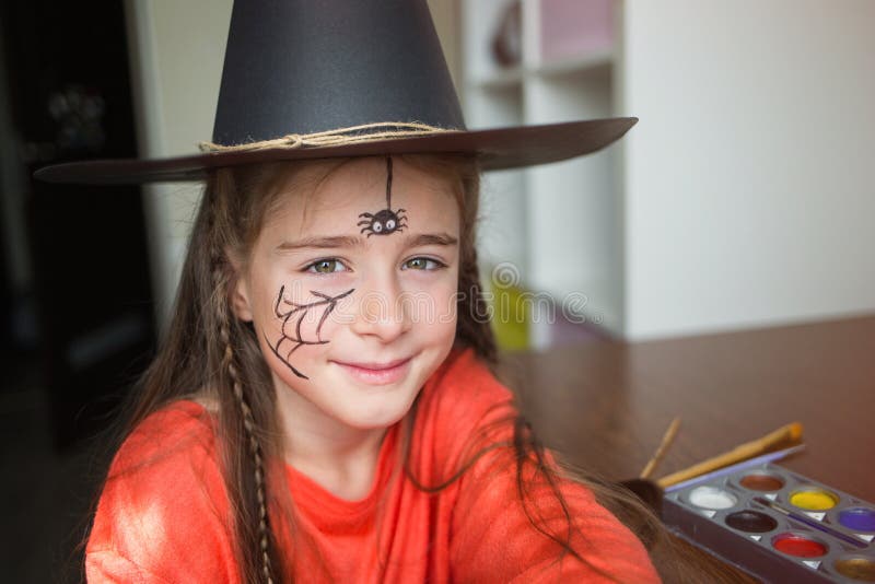 Preparation For Halloween. Child In A Witch Outfit Doing Face Painting.  Cute Spider. Idea Of Simple Suit, Diy Stock Image - Image Of Greasepaint,  Brush: 156295303