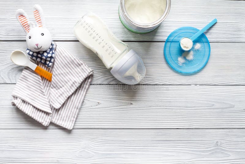 Preparation of mixture baby feeding on wooden background top view