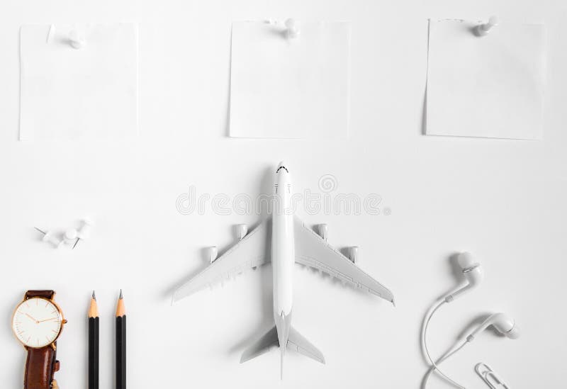Preparation for Traveling concept, watch, airplane, pencils, paper noted, earphone, push pin. royalty free stock images