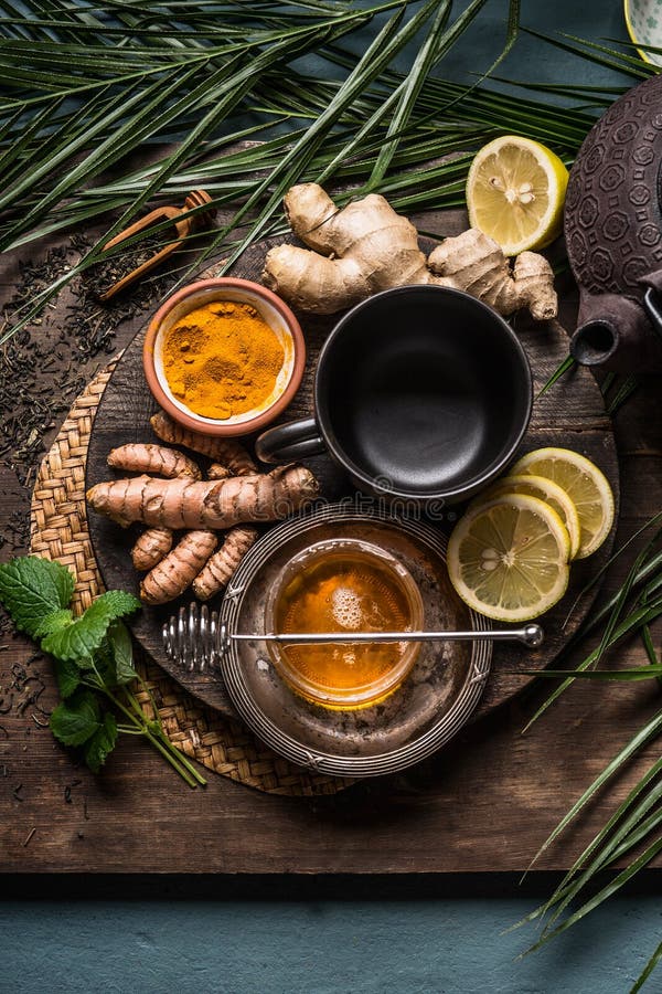 Preparation of Turmeric ginger tea with fresh ingredients, top view. Healthy herbal immune boosting