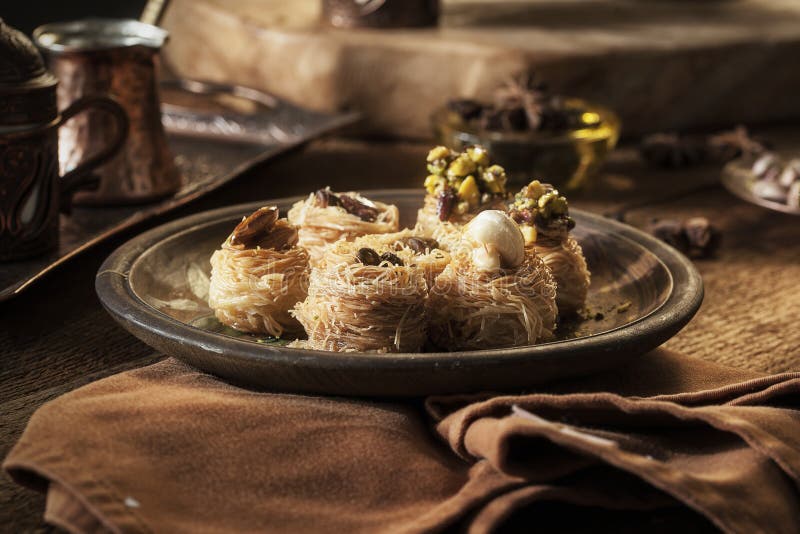 Baklava - turkish dessert with pistachio on a oriental pattern tray. Baklava - turkish dessert with pistachio on a oriental pattern tray
