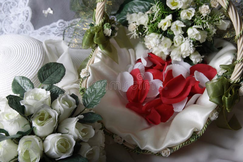 Wedding arrangement of bridal bouquet, flower girl basket of rose petals and bride hat. Wedding arrangement of bridal bouquet, flower girl basket of rose petals and bride hat