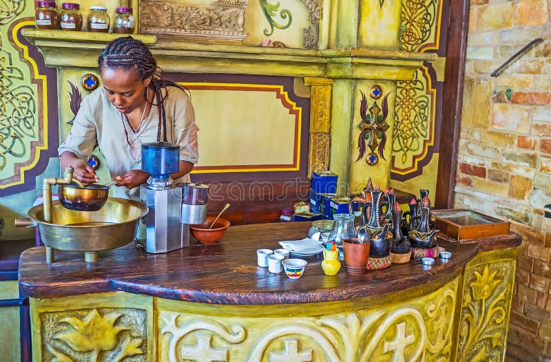 KIEV, UKRAINE - JUNE 4, 2017: The first step to prepare the Ethiopian coffee ceremony is to wash green coffee beans, on June 4 in Kiev. KIEV, UKRAINE - JUNE 4, 2017: The first step to prepare the Ethiopian coffee ceremony is to wash green coffee beans, on June 4 in Kiev.