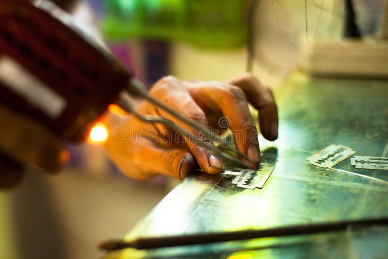 Unidentified master prepare tools for traditional tattoo bamboo, Dec 24, 2012 in Koh Chang. Thai tattooists are very popular among tourists prices range from 500 baht and up