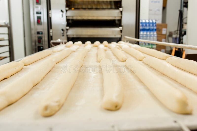 Prepared baguettes in front bread oven.
