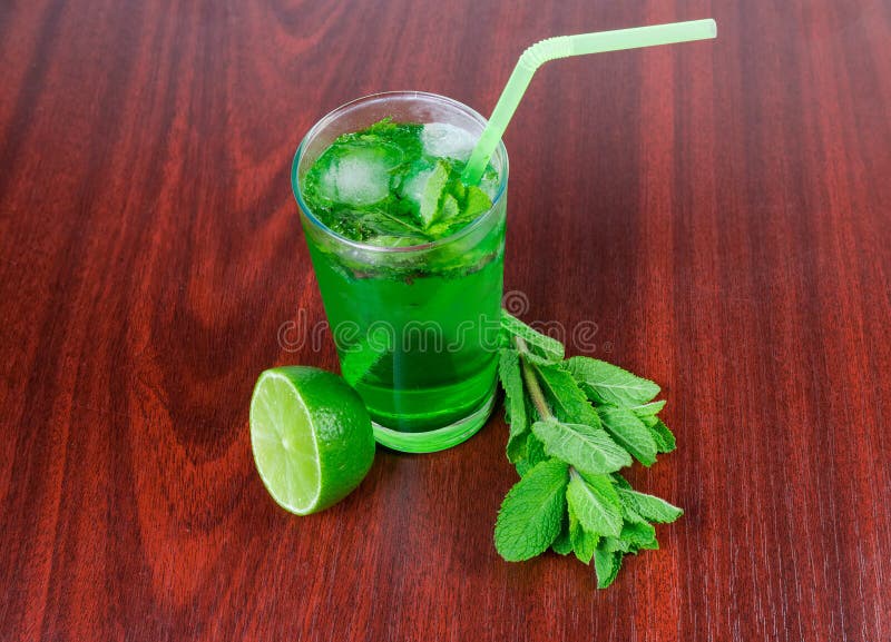 Cold Mint Drink, Mint Twigs and Lime on Wooden Table Stock Photo